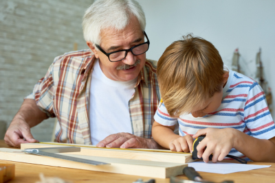 grandfather teaching grandson carpentry